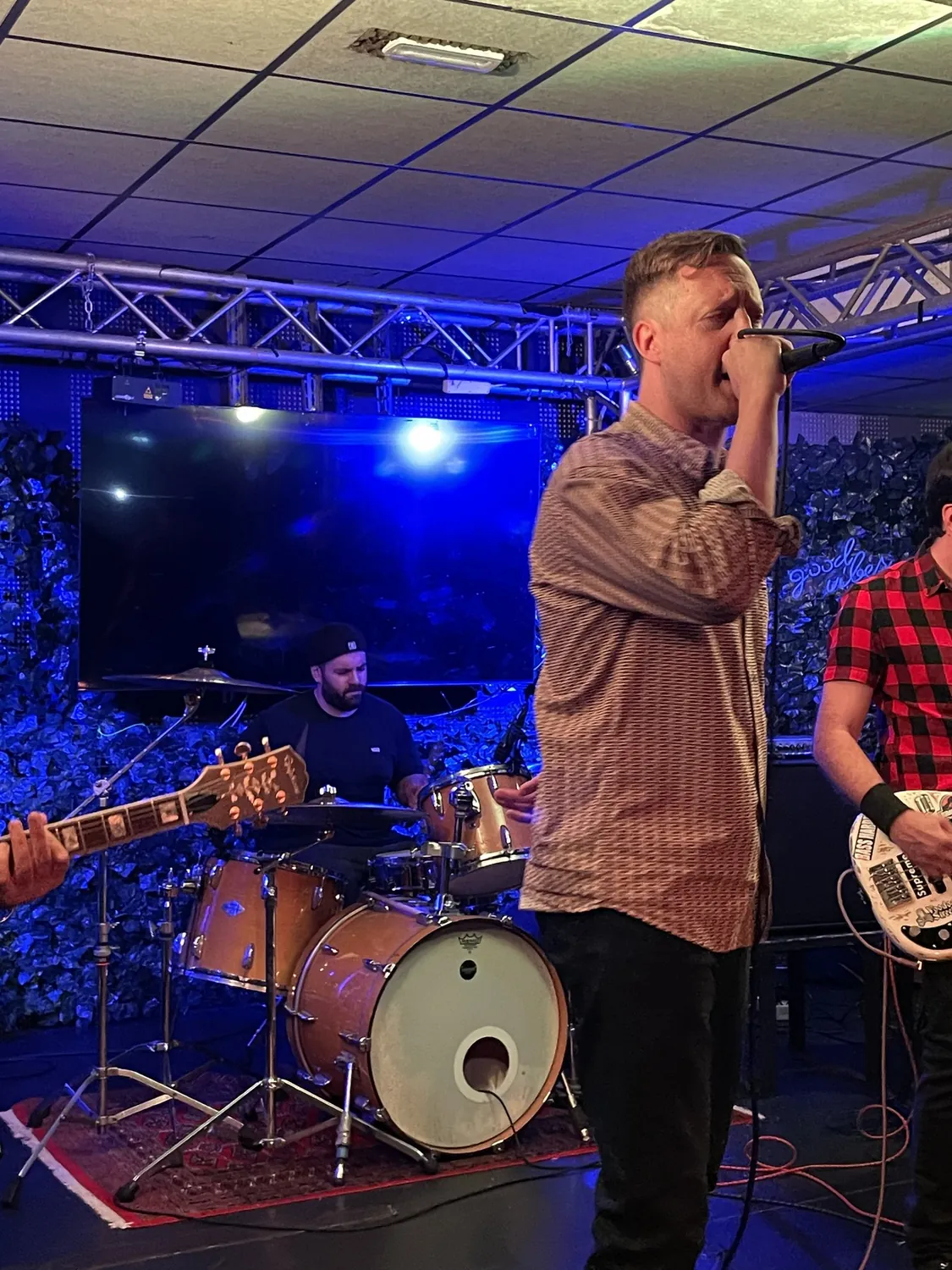 Vocalist in front of the drum kit